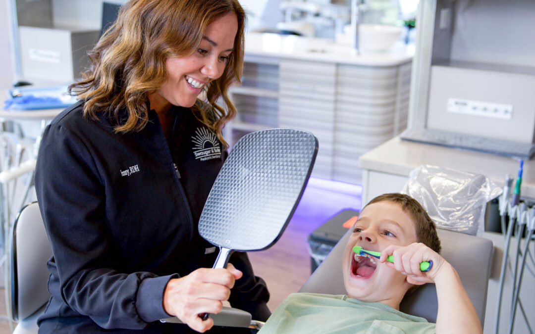 Dentist and a child brushing his teeth